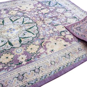 Low-pile traditional rug featuring purple, beige, and green floral patterns, with a corner folded over against white.