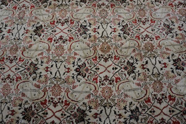 Cream, red, and black traditional rug pattern with dense floral motifs and stylized paisley shapes.