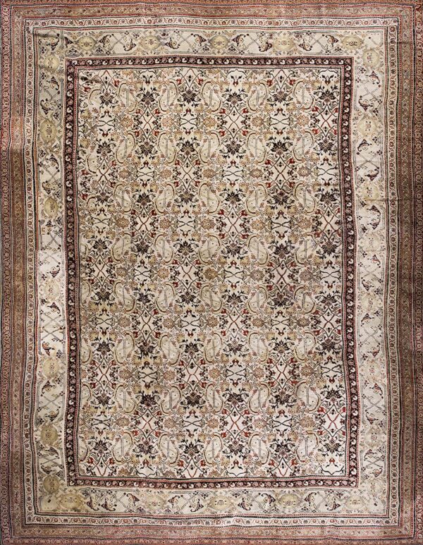 Dense ivory rug with repeating floral and geometric designs in dark brown, red, and tan.