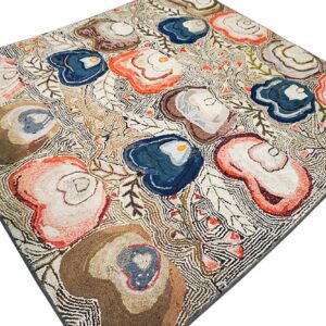 High-pile rug featuring large organic shapes in blue, coral, and brown on a dense, off-white linear ground.
