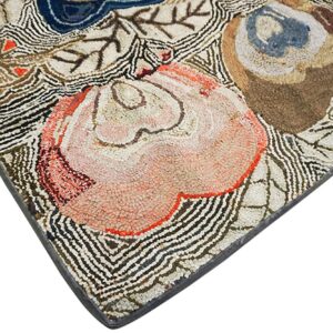 Highly textured corner view of a rug with pink, blue, and brown floral patterns and striped background details.