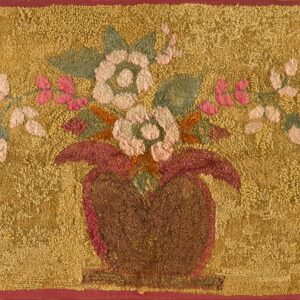 Textured gold rug featuring pink and cream flowers, green leaves, and a reddish-brown vase.