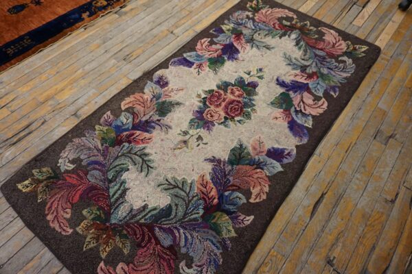 Textured rectangular rug with a central rose motif and colorful leaves on a dark brown background.
