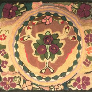 Hooked square rug with a burgundy, green, and gold floral medallion centered on a multicolor, textured field.