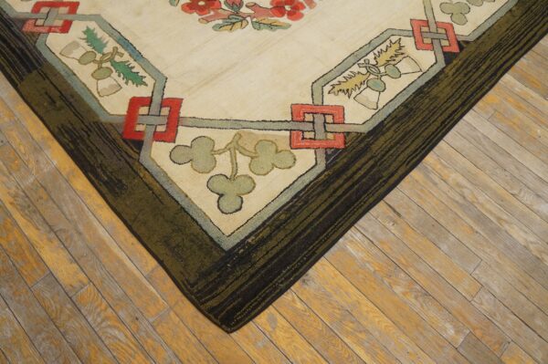 Textured rug corner featuring cream, red, and green stylized floral and geometric motifs on wooden planks.