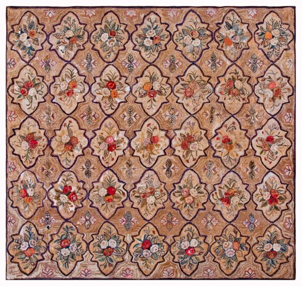 Tan, textured rug with a repeating lattice design framing bouquets of red, pink, and cream roses.