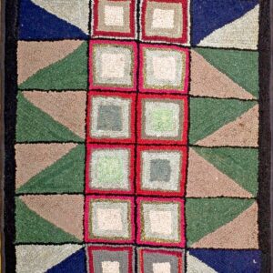Multi-colored hooked rug with a geometric block design using navy, green, red, and taupe.