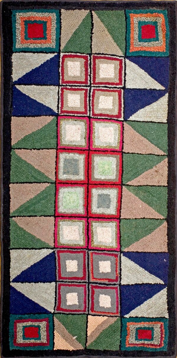 Multi-colored hooked rug with a geometric block design using navy, green, red, and taupe.