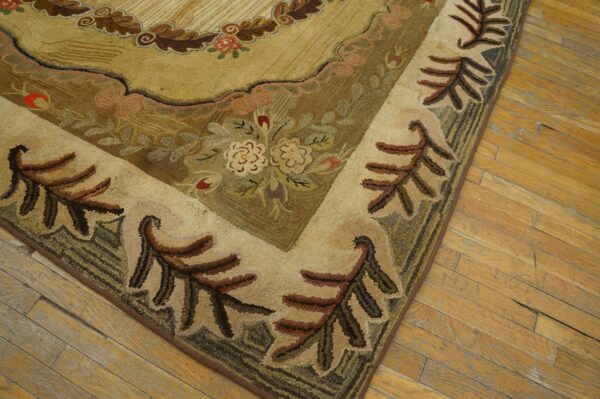 High-pile rug corner with tan, brown, and green floral motifs rests on worn hardwood floor.