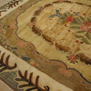 Close-up of a textured rug in tan and brown with a rustic floral bouquet on wood planks.