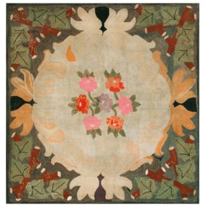 Hooked rug with a central bouquet of pink and orange flowers bordered by large pale yellow scrolls and dark foliage.