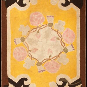 Stylized floral rug featuring a golden yellow field, pink roses, and dark brown foliate borders.