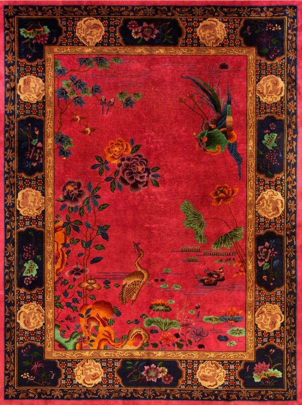 Vivid red rug with a low pile and detailed pattern of birds, flowers, and a wide dark navy border.
