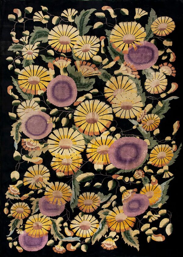 Black rug with a dense floral pattern of yellow, gold, and purple blossoms and green leaves.