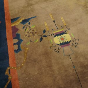 Tan rug with a navy, orange, and brown border, featuring floral, bird, and stylized lantern motifs.