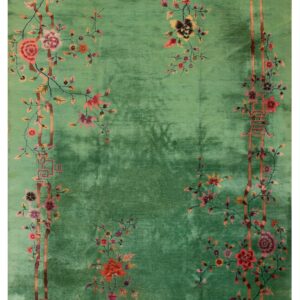 Variegated green rug with a detailed border pattern of blossoming vines, vases, and bamboo accents.