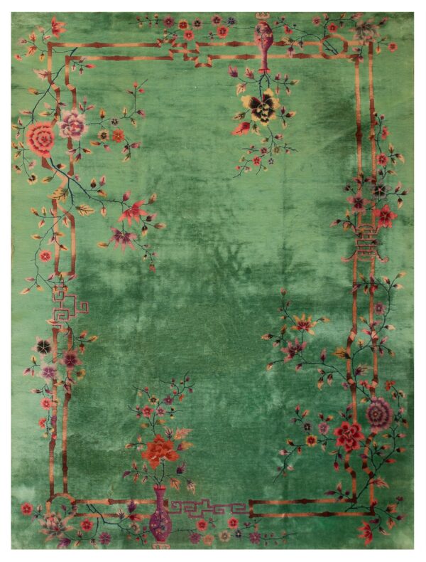 Variegated green rug with a detailed border pattern of blossoming vines, vases, and bamboo accents.