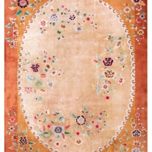 Rectangular rug featuring a soft tan oval field surrounded by rust-colored ornate floral borders.