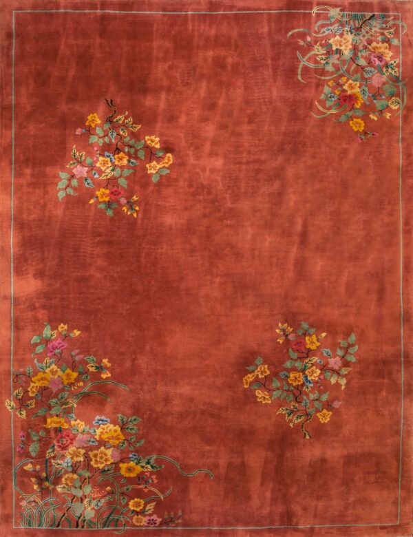 Rust-colored rug with high pile and multicolored floral clusters in the corners and upper field.