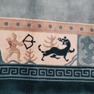Teal and tan rug border features a Greek key design, archer figure, and running stylized animal motifs.