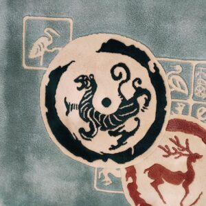 Sculpted teal rug featuring a circular cream and dark tiger design overlapping a red deer silhouette.