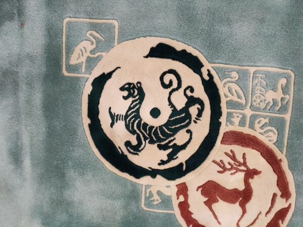 Sculpted teal rug featuring a circular cream and dark tiger design overlapping a red deer silhouette.