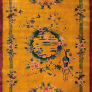 Golden yellow rug with a purple border, green geometric frame, and stylized floral and landscape motifs.