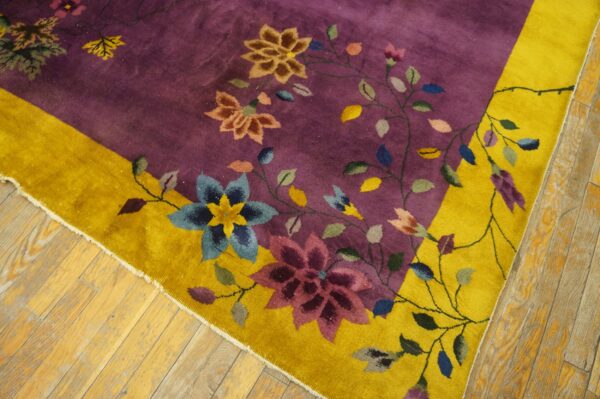 Plush purple rug featuring colorful scrolling floral designs and a wide golden yellow border on wood flooring.