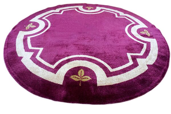 Plush round purple rug displaying a decorative cream frame design and gold leaf motifs.