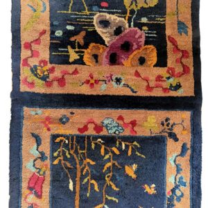 Dark navy high-pile rug with tan borders framing colorful stylized motifs of birds and foliage.