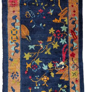 Vertical view of a high-pile navy runner featuring multicolored floral vines and a thick tan border.