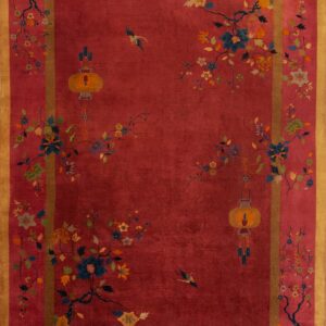 Crimson rug with gold border displaying stylized floral branches, birds, and hanging yellow lanterns.