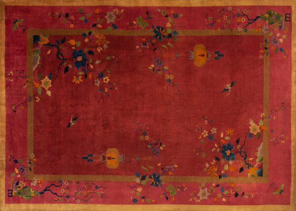 Red rug with a gold border and scattered colorful floral motifs, birds, and lanterns.