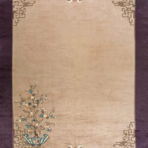 Beige rug with a colorful potted flowering tree design and geometric borders on a dark purple background.