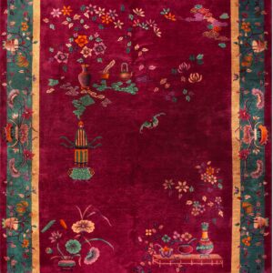 Oriental rug featuring a magenta field, teal floral borders, and detailed vases and botanical motifs.