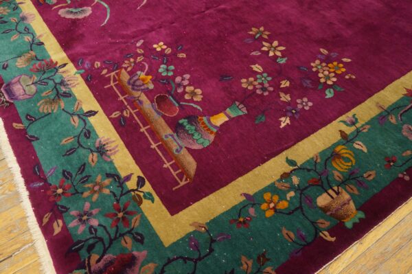 Vibrant magenta rug featuring colorful floral vines, vases, and a wide teal and gold border on wood flooring.