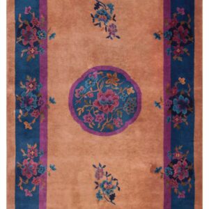 Sienna field rug featuring a bold blue and magenta floral medallion and wide botanical borders.