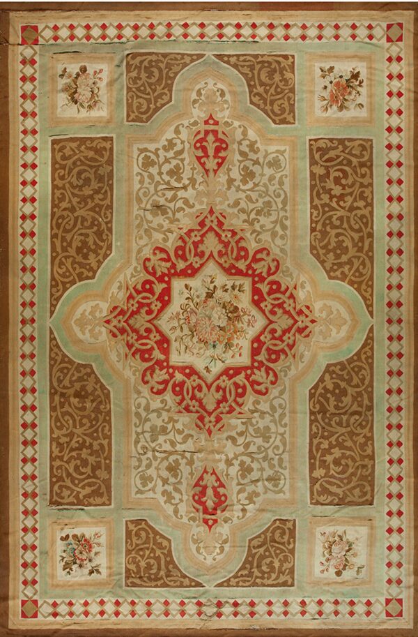 Low-pile rug with red, tan, and brown ornate patterns, featuring a central medallion and floral corner squares.