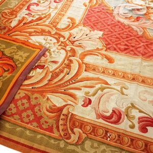 Ornate cream, orange, and red rug with scrolling botanical and geometric border designs in a close-up shot.
