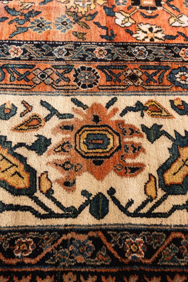 A close-up shows traditional floral and geometric motifs in rust, navy, teal, and cream colors.