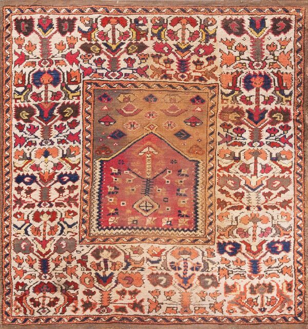 Low-pile rug displaying intricate geometric and floral patterns in red, cream, blue, and earthy browns.