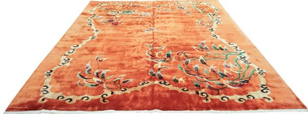 Salmon-colored high-pile rug with a detailed multicolored floral and vine central pattern and scrolling border.