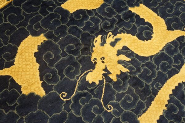 Plush rug detail showing a gold dragon against a dark blue background with scrolling cloud motifs.