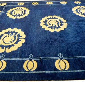 Deep blue rug with contrasting yellow stylized floral medallions and a geometric border pattern.