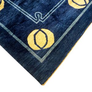 Detail of a navy blue rug corner featuring yellow circular patterns and light blue geometric borders.