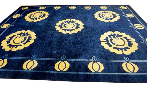 Navy blue rug with vibrant yellow floral motifs and a patterned light blue border detail.