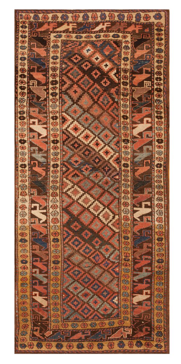 Dark runner rug with a geometric diamond field and stylized bird figures in rust and blue borders.
