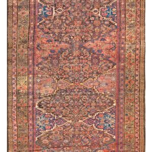 Narrow runner rug featuring a detailed traditional pattern in muted coral, navy blue, brown, and sage.