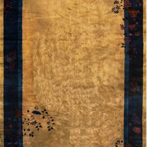 Gold rug with high sheen and a wide navy border featuring pink and teal stylized floral motifs.