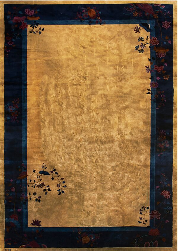 Gold rug with high sheen and a wide navy border featuring pink and teal stylized floral motifs.